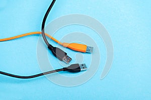Multicolored computer cable USB isolated on blue photo