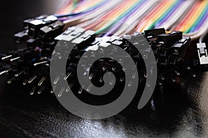 Multicolored computer wires on a black background