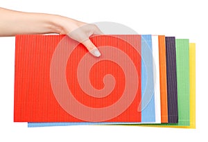 Multicolored corrugated cardboard in a hand