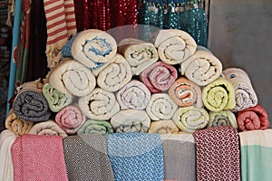 Multicolored cotton towels with graphic ornament for hamam on the counter of the oriental bazaar