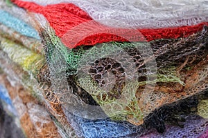 Knitted woolen shawls stacked