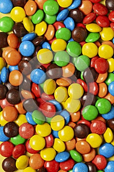 Multicolored dragee, candy background,