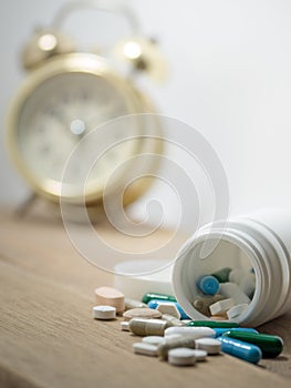 Multicolored of Drug and capsule is on the wooden table. Closeup. We are against drugs anti drugs, cure in container for health.