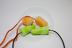 Multi-colored earplugs isolated on a white background. Close-up. Selective focus