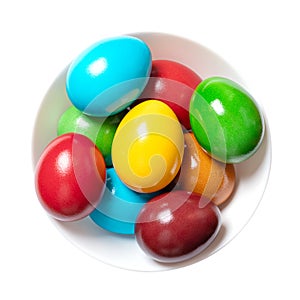 Multicolored Easter eggs, rainbow colored Paschal eggs in a white bowl