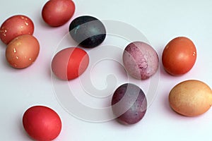 Multicolored easter painted eggs in red colors on a pink background
