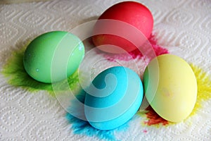 Multicolored eggs and traces of a on a white paper napkin. concept Easter preparations.