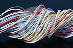 Multicolored electrical cable on dark background