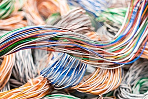 Multicolored electrical wires chaotically intertwined. Abstract color technology background. Many telephone communication cables