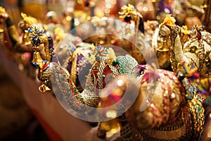 Multicolored elephants souvenirs of different colors with their trunk up, Elephant toys in the Indian market