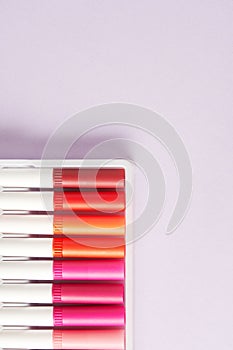 Multicolored felt-tip pens with orange and pink spectrum in the corner