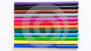 Multicolored felt-tip pens on a white background