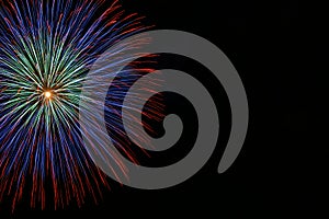 Multicolored fireworks isolated in dark background close up with the place for text