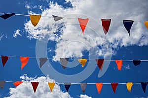 Multicolored flags against the blue sky
