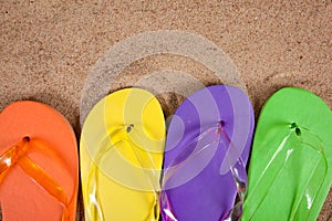 Multicolored flipflops in the sand