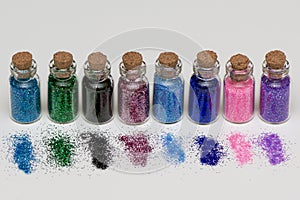 Multicolored glitter for nail manicure and makeup in banks on a white background. macro