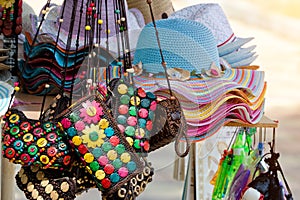 Multicolored bags and hats. Street market. Close up