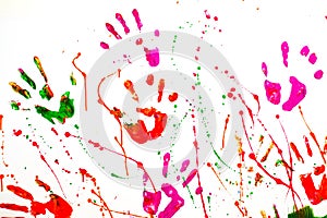 Multicolored handprints on a white wall