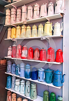 Multicolored kettles collection lined up on shelves