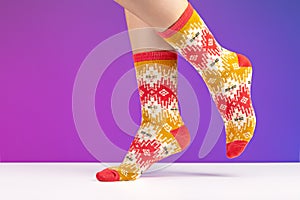 Multicolored knitted socks with ornament. The concept of cozy home atmosphere in winter.