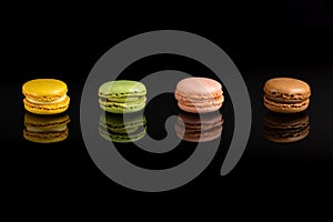 Multicolored macarons on a black background