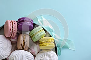 Multicolored macaroons or macarons in a turquoise box