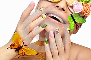 Multicolored manicure with pictures of butterflies.