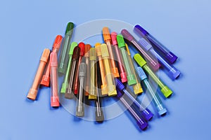 Multicolored markers of different shades on a blue background