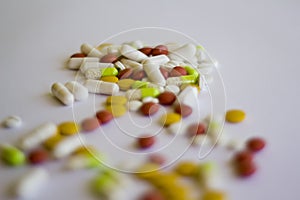 Multicolored medicine pills on a white background