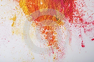 Multicolored mixed holi powder scattered on white background