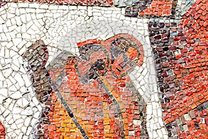 Multicolored mosaic panel of red-orange smalt, elements of the old Soviet monument.