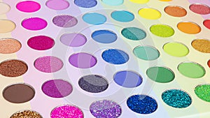 Multicolored neon eyeshadow palette. Make-up. Beauty products. Bright colorful beautiful background. Tool for makeup artist.