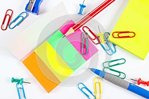Multicolored office stationery on white desktop closeup