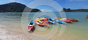 Multicolored paddle boats / kayaks at a sand beach on Phi Phi Island, Thailand