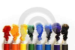 Multicolored paint tubes on a white background