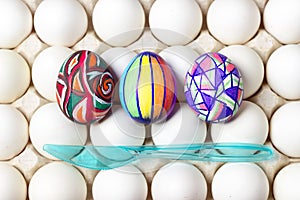 Multicolored painted easter eggs on white tray, food photography