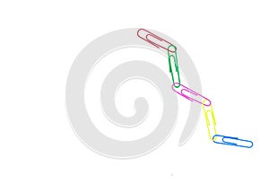 Multicolored paper clips in the form of a chain on white background. Decorative paper clips in pink, yellow, green, red and blue