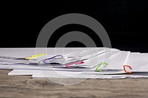 Multicolored paper clips on paperwork