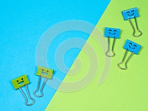 Multicolored paperclip on blue green background