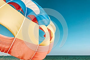 A multi-colored dome of a parachute in the sky as a background