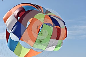 Multicolored Parasail in flight photo