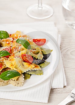 Multicolored pasta on light background