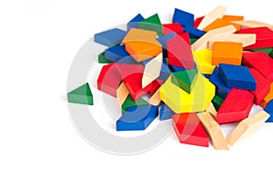 Multi Colored pattern blocks on a white wooden background.Isolate.