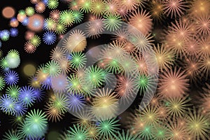 Multicolored pattern of small flower shapes on a black background.