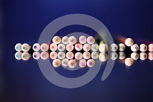 Multicolored pencils on the table. A stack of colored pencils ti