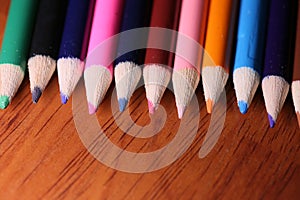 Multicolored pencils on the table. A stack of colored pencils ti