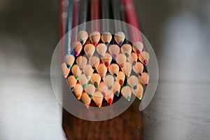 Multicolored pencils on the table. A stack of colored pencils ti