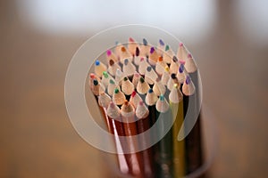 Multicolored pencils on the table. A stack of colored pencils ti