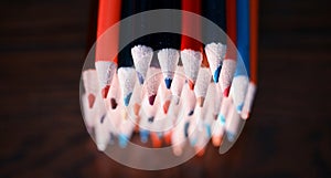 Multicolored pencils on the table. A stack of colored pencils ti