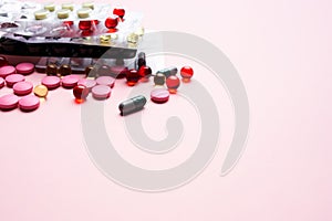 multicolored pills medicine pain reliever pink background